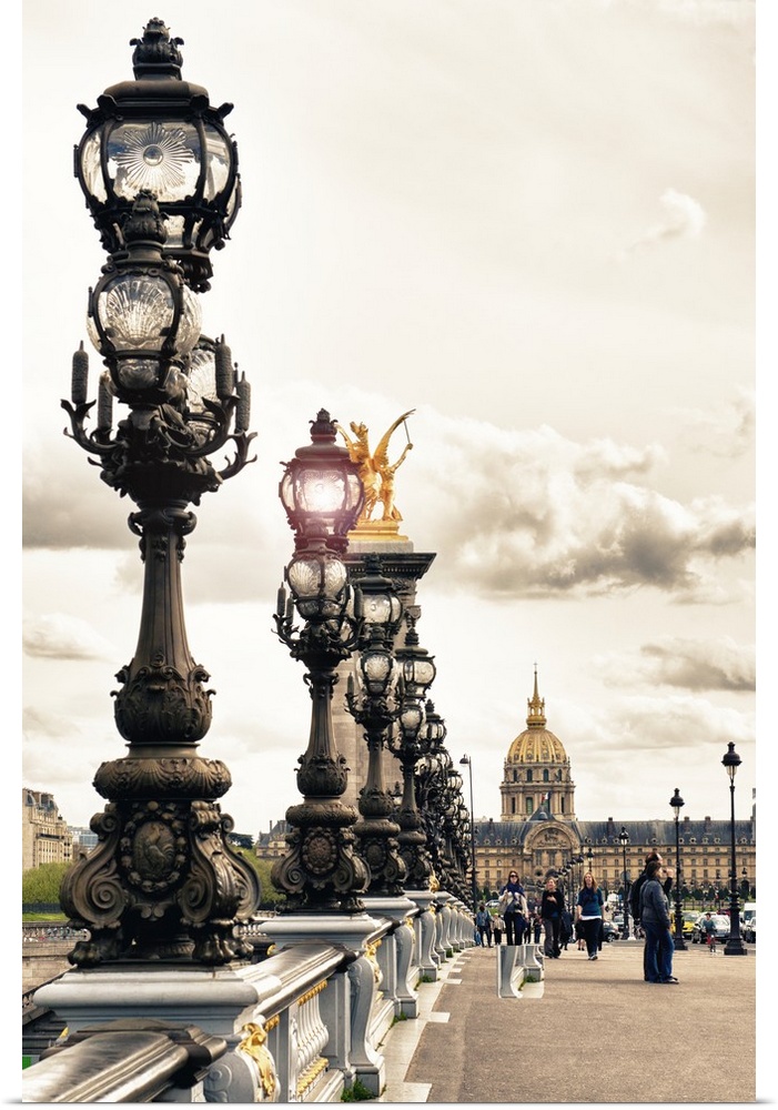 Row of detailed iron street lamps on the Pont Alexandres III in Paris, France.