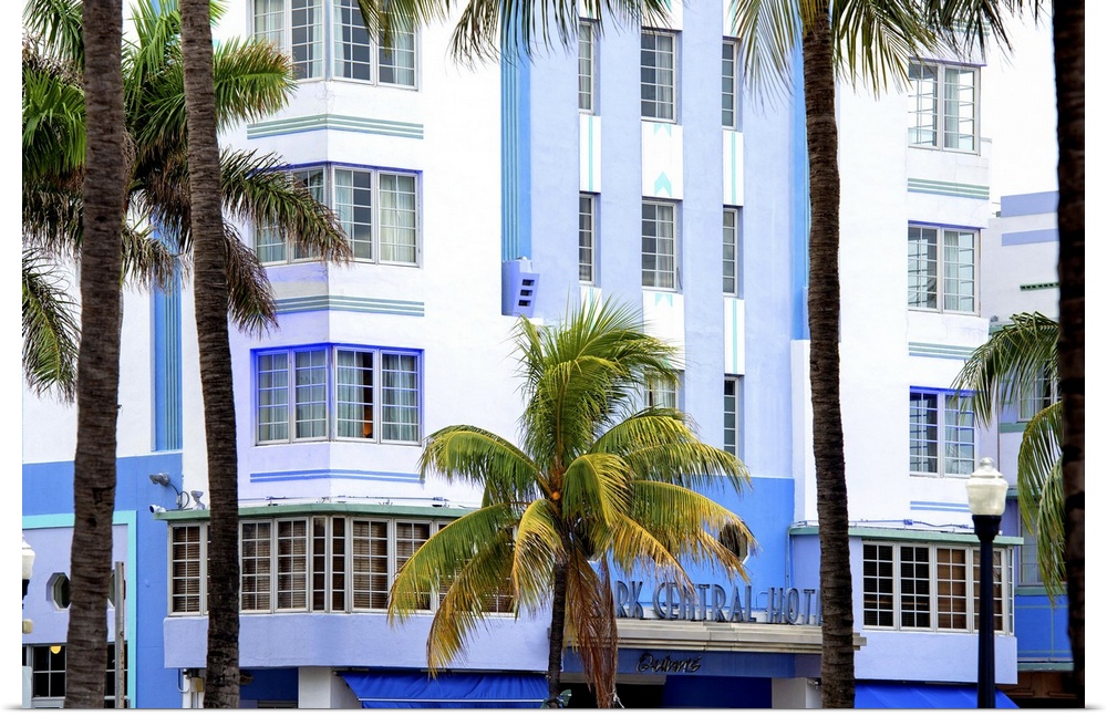 Palm trees frame the blue Art Deco architecture of the Park Central Hotel in Miami Beach.