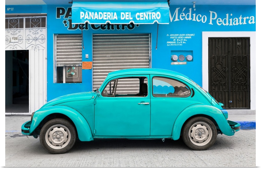 Photograph of a turquoise Volkswagen Beetle parked in front of a blue building. From the Viva Mexico Collection.