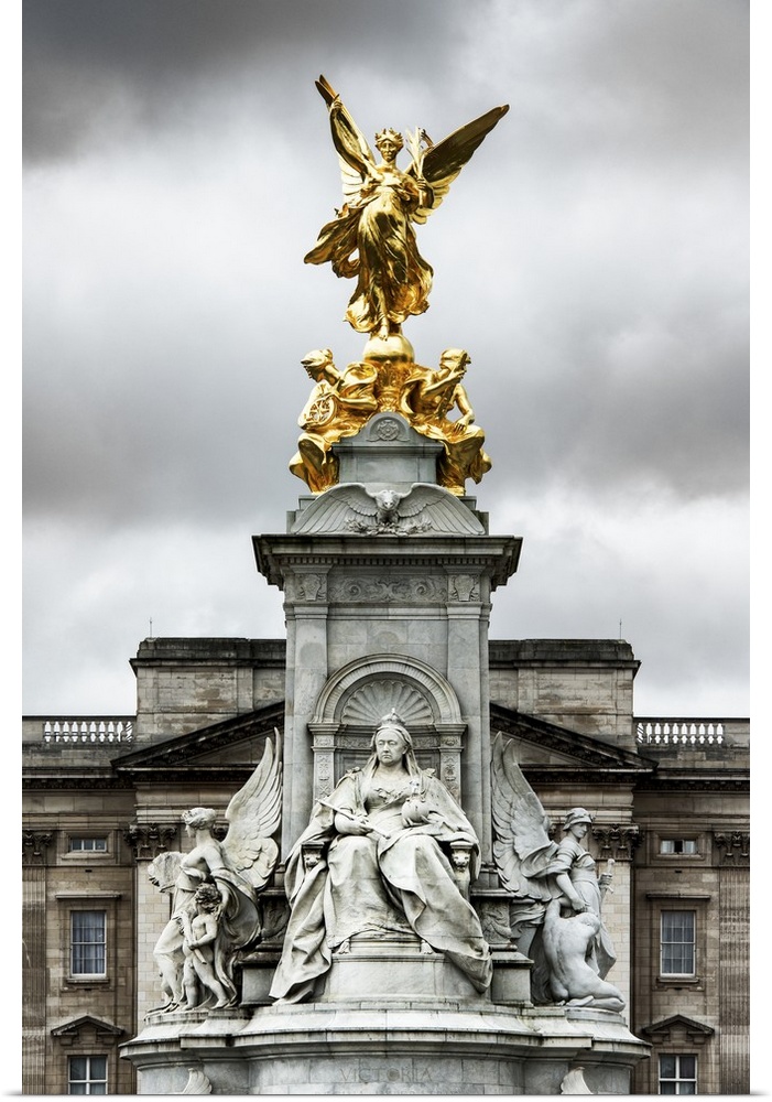 View of the golden statue at the top of the Victoria Memorial under a cloudy sky.