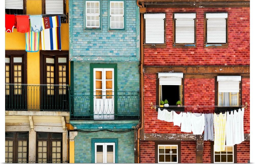 These are typical colourful facades with hanging linen in the Ribeira district of Porto (Portugal).