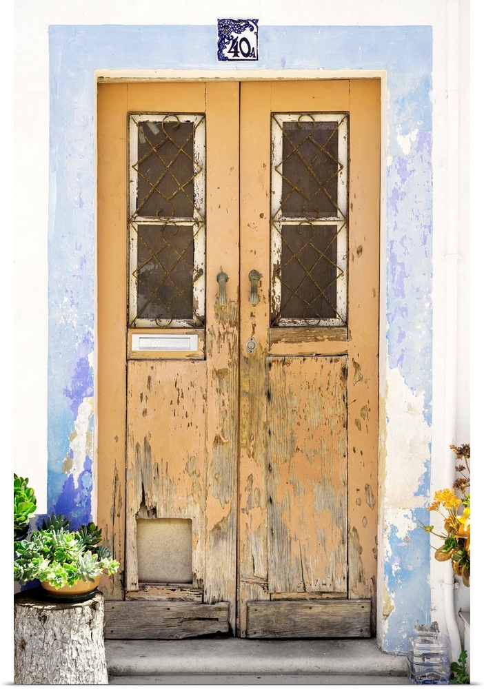 It's an old dark yellow door entrance to a traditional house in Portugal.
