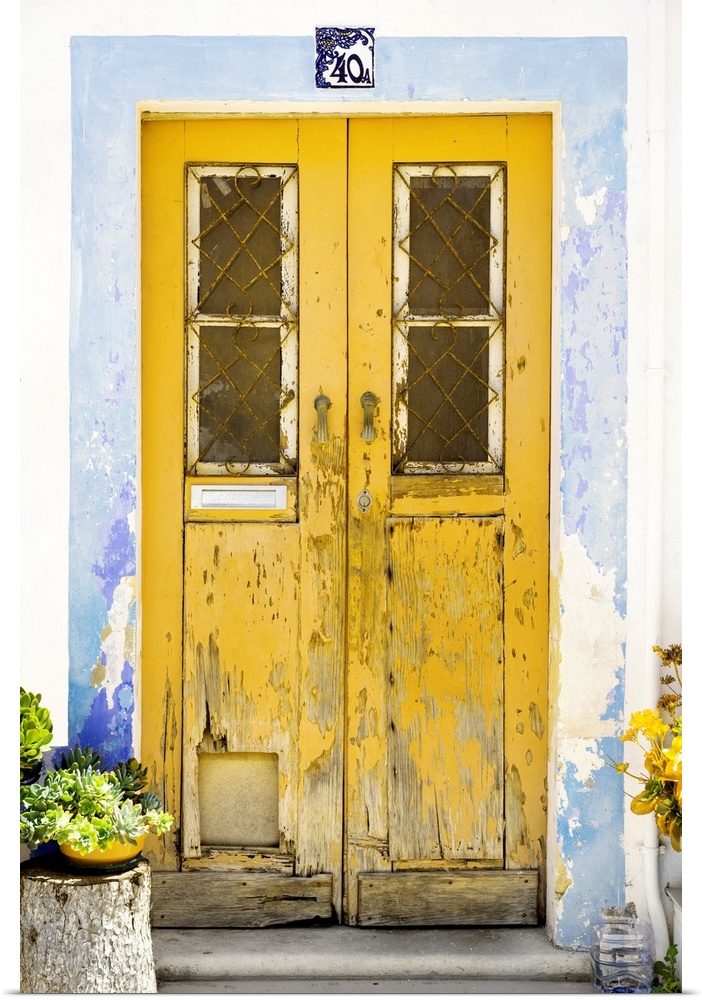 It's an old yellow door entrance to a traditional house in Portugal.