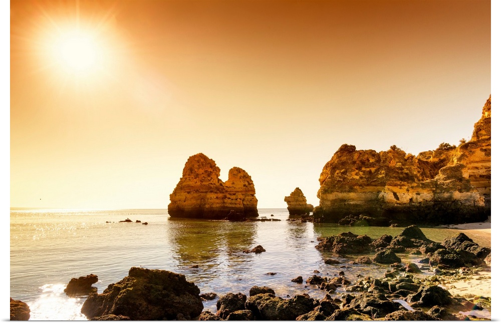 It's a beautiful view of a sunset on the orange cliffs in Lagos (Portugal).