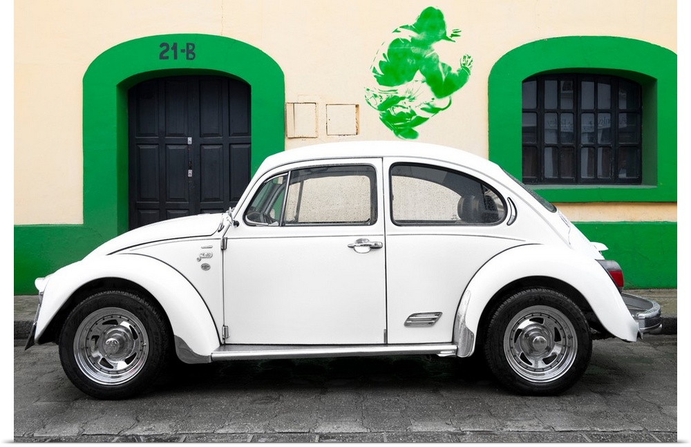 Photograph of a classic white Volkswagen Beetle parked in front of a building with a green trim wall and green graffiti. F...