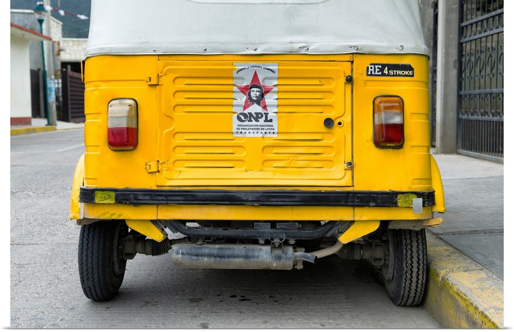 Close-up photograph of the rear side of a yellow tuk tuck (taxi) in Mexico. From the Viva Mexico Collection.