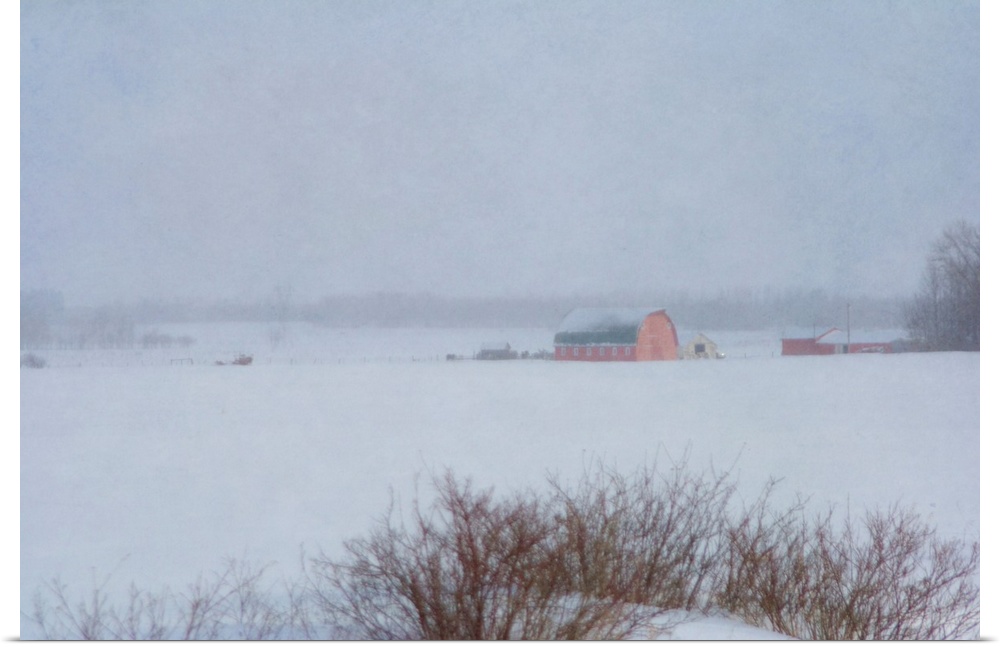 Pictorial photograph of a red country barn on a farm in winter during a snowstorm.
