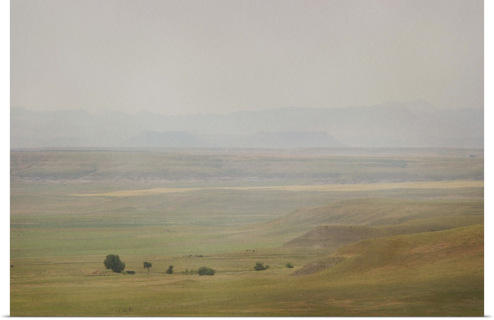 A pictorialist landscape photograph of a western prairie landscape of Montana, USA. Farms up against the buttes form a sce...