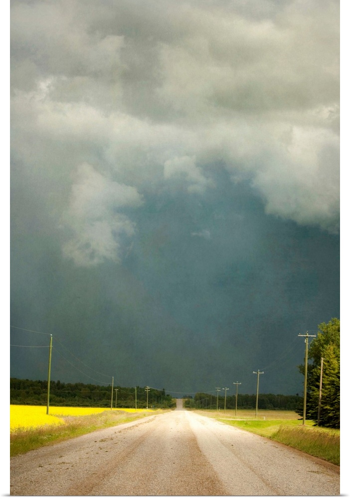 Storm clouds along a lonely stretch of gravel road in the country.