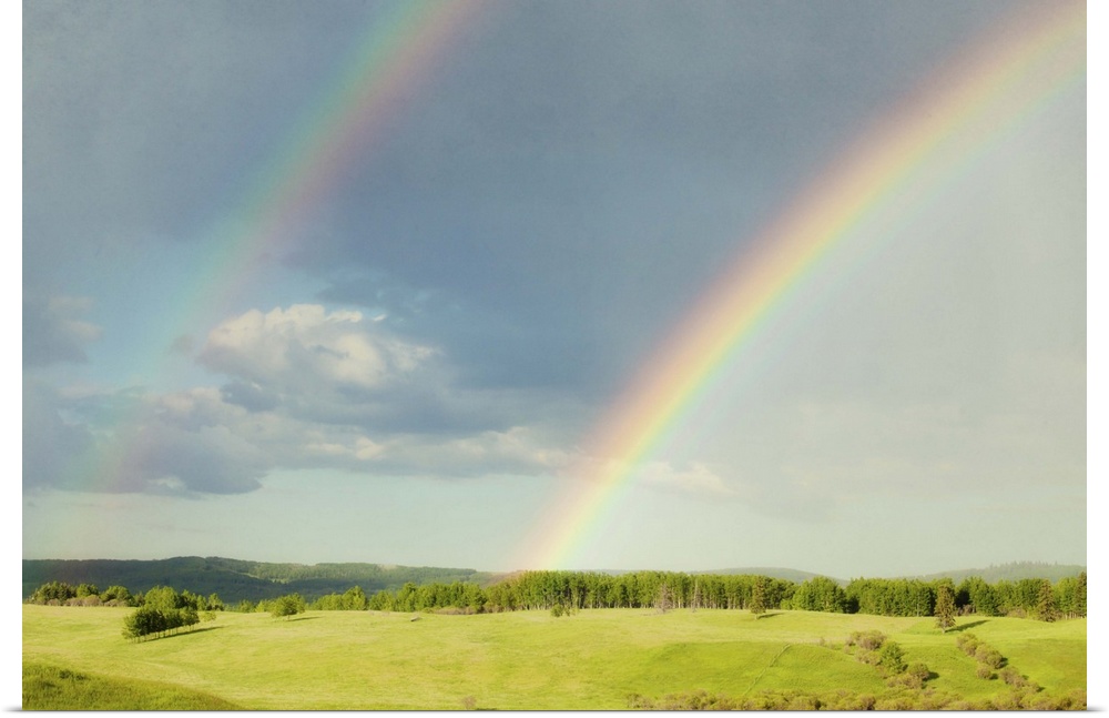 Photograph of a lush green landscape with a double rainbow overhead.