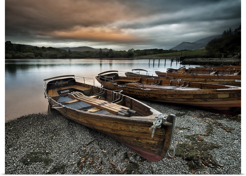 A row of wooden boats on the shore at Keswick, Cumbria.