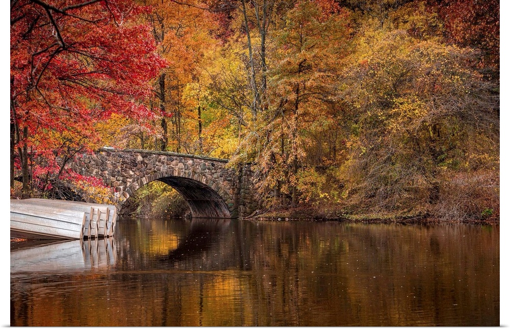 Fall colors around a bridge and lake in Clove Lakes Park, Staten Island, New York.