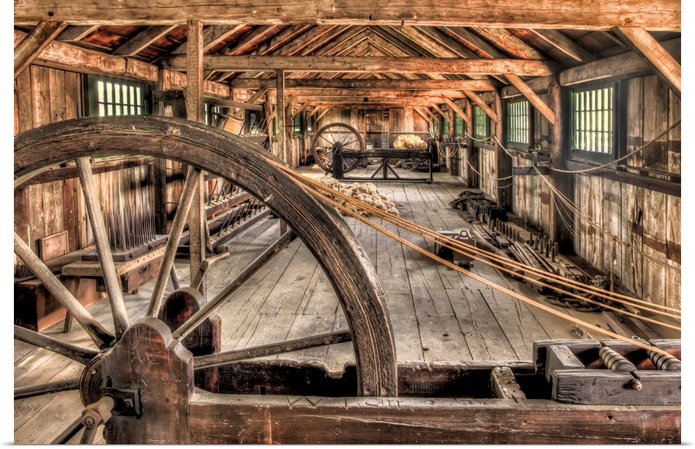 The interior of an old rope factory, with large wooden wheels.