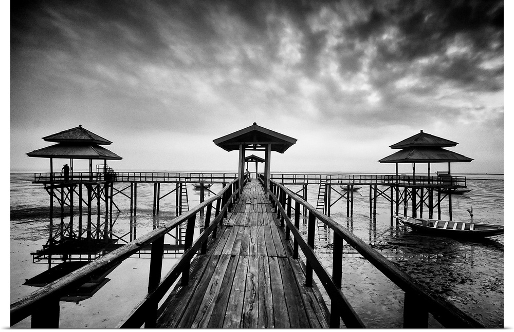 Black and white photo of a wooden pier in Kenji Beach, East Java, Indonesia.