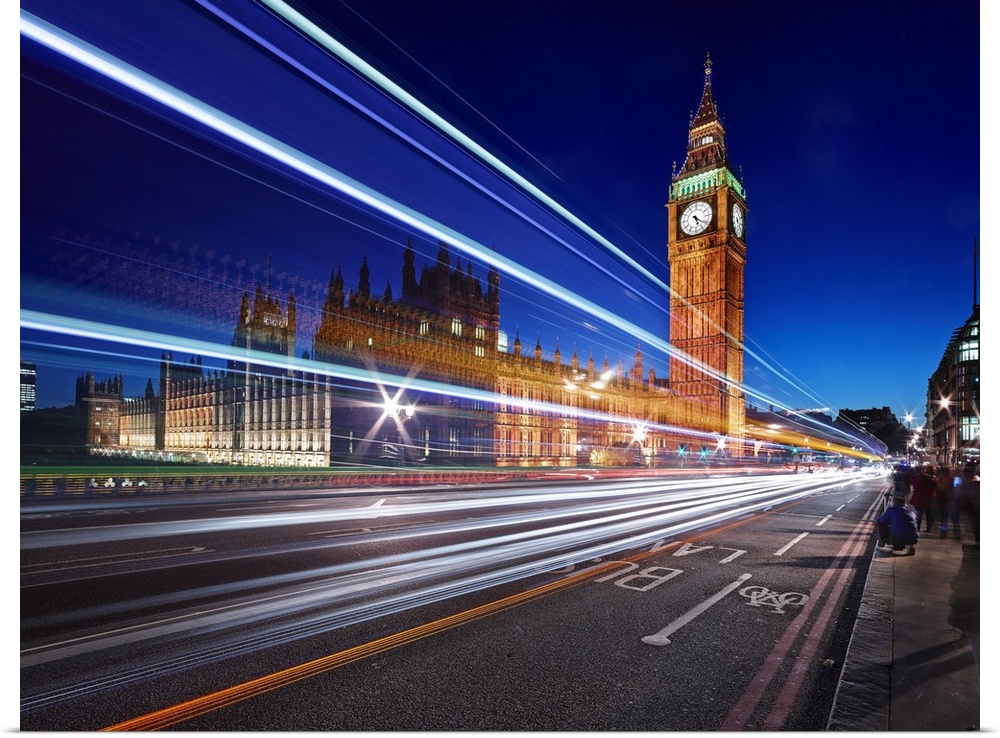 Light trails from passing cars in front of Big Ben and Parliament in London, England, in the evening.