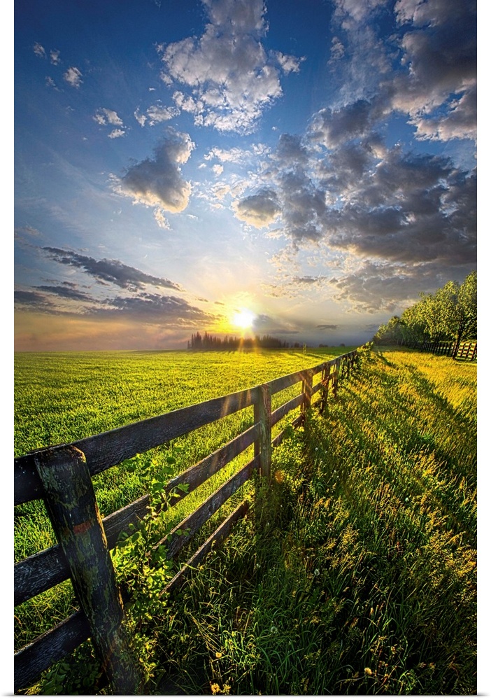 Sunlight and dramatic clouds over a fence in farmland, Wisconsin.