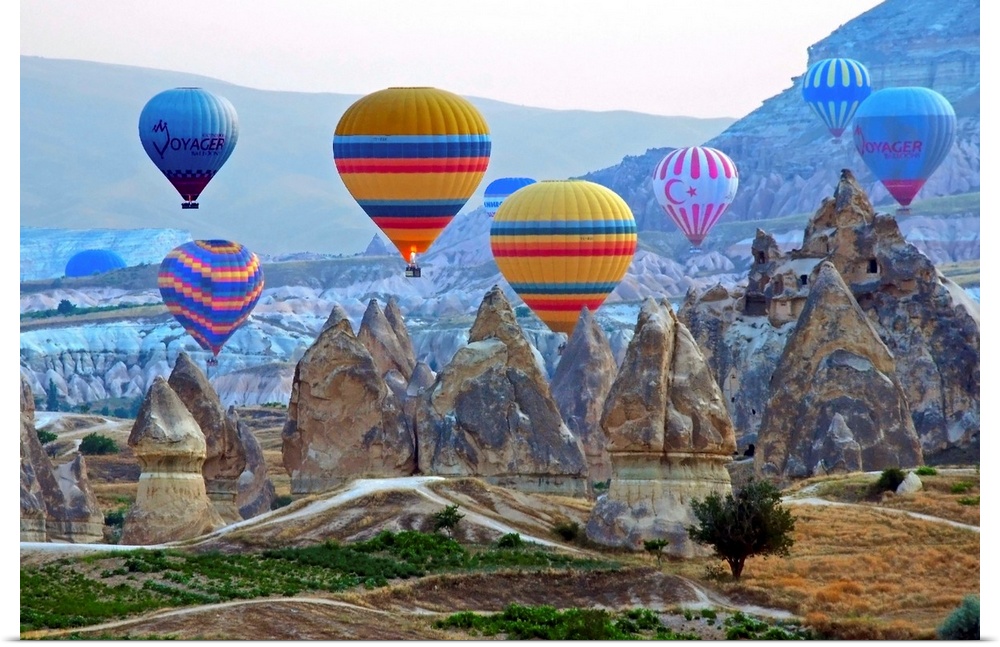 Colorful hot air balloons over the rocky landscape of Cappadocia, Turkey.