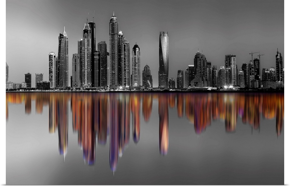 Black and white image of hte Marina Towers in Dubai, with a reflection in color.
