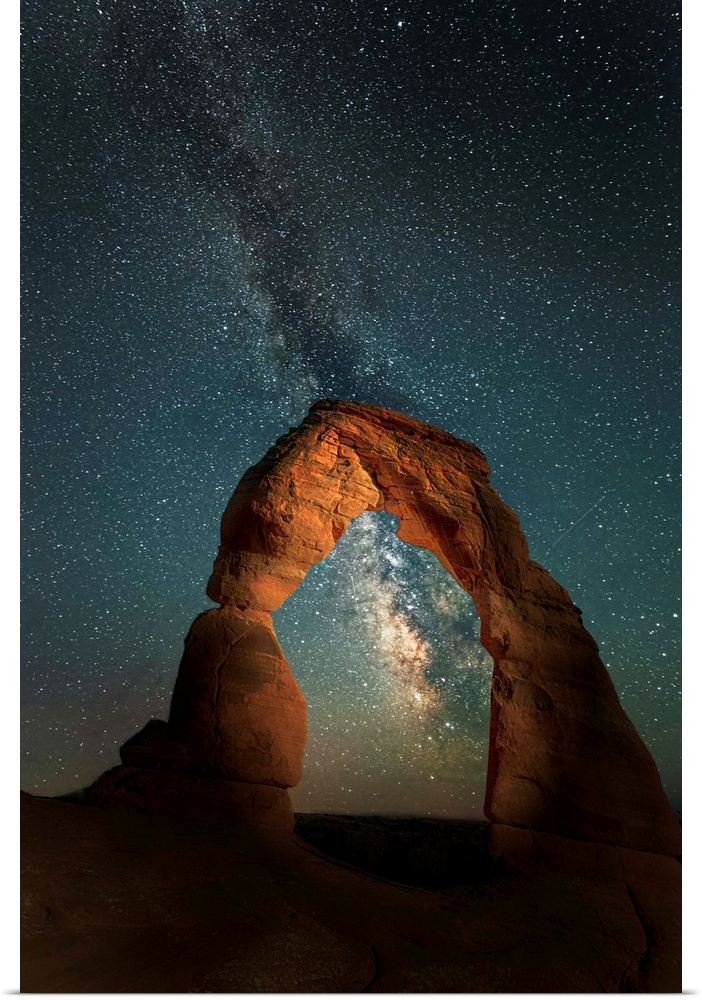 The Milky Way Galaxy in the night sky seen through Delicate Arch, in Utah.
