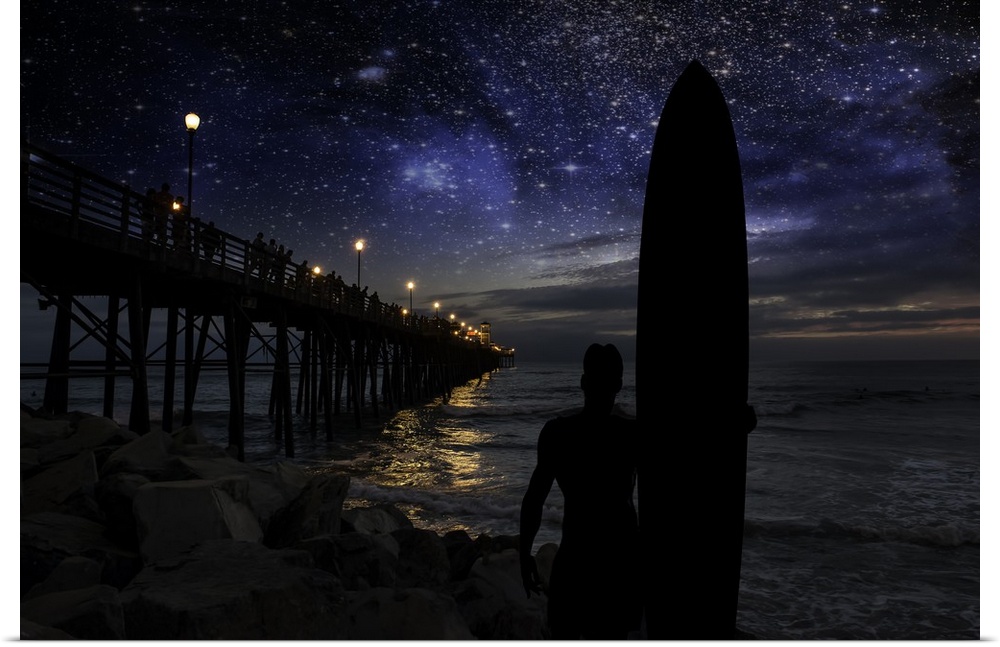 A silhouetted long board surfer watches the stars and dreams of big waves near the Oceanside Pier. Oceanside is 40 miles n...