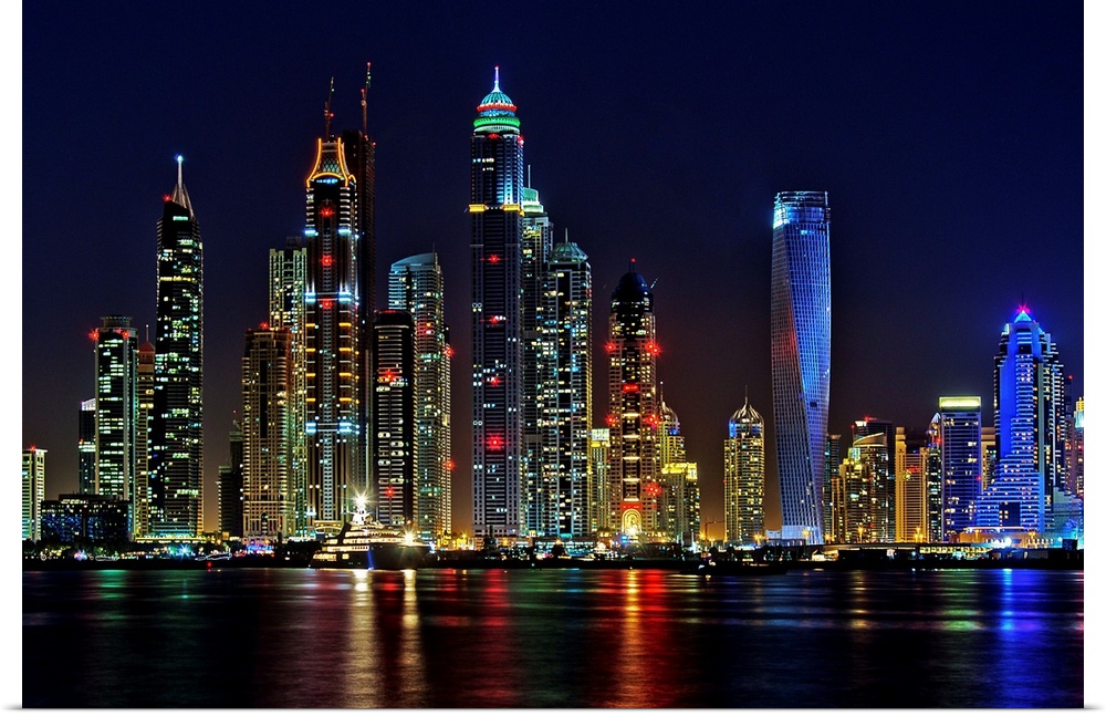 Dubai skyline at night lit up in neon lights.