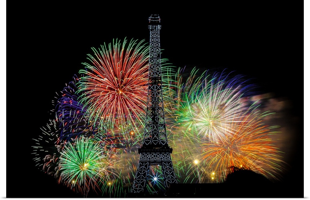 Fireworks exploding in the air behind the Eiffel Tower in Paris.
