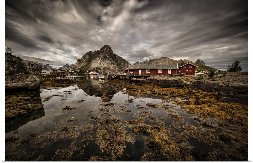 Dynamic photograph of a fishing village under cloudy skies.