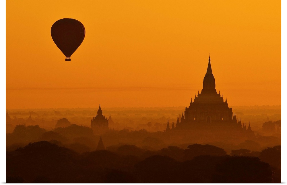Silhouette of a balloon over temples in the morning in Bagan, Myanmar