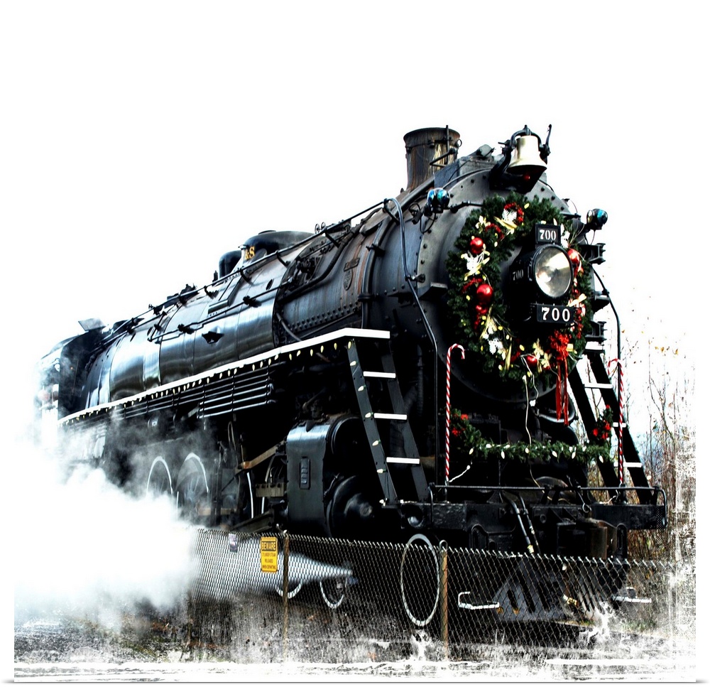 A black locomotive with a festive wreath on its nose.