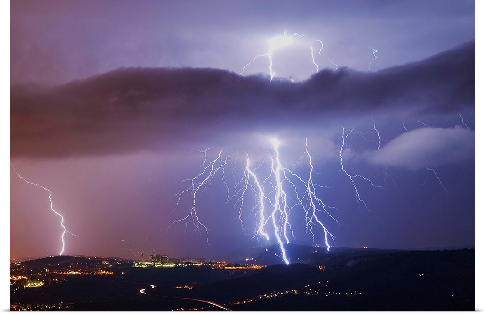 This is a single exposure image of several consecutive lightning strikes into hills above Trieste, Italy.