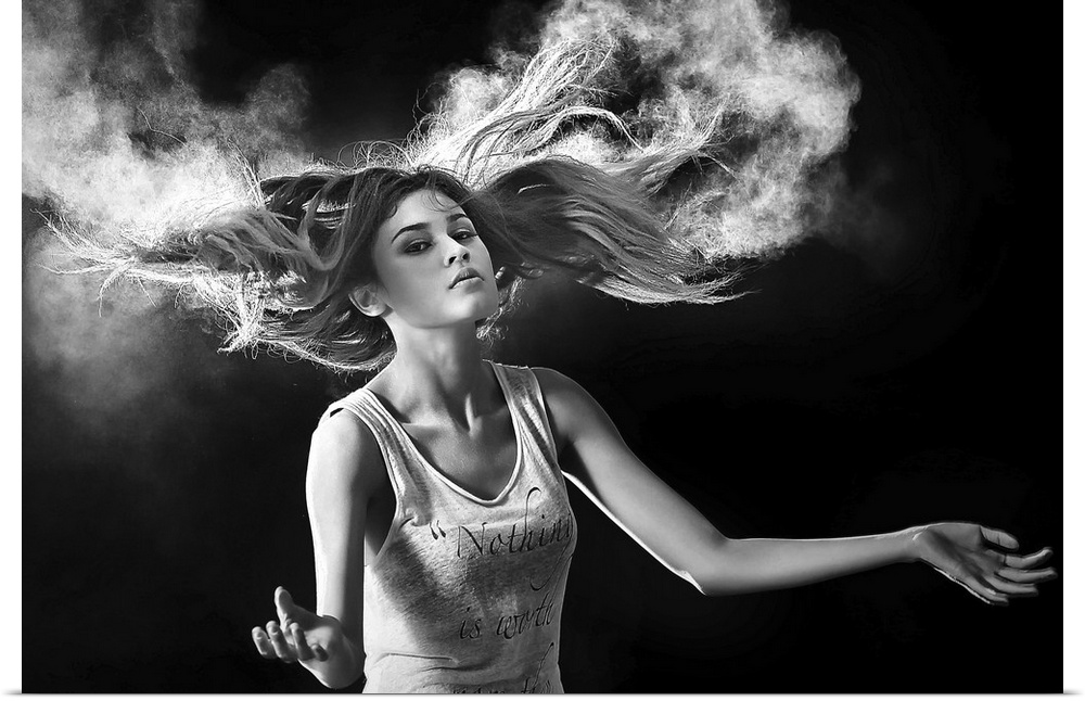 Black and white portrait of a beautiful woman with hair swirling around her.