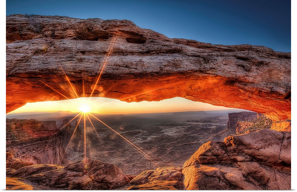 The sun rises in Canyonlands National Park and for a brief moment illuminates the breathtaking Mesa Arch.