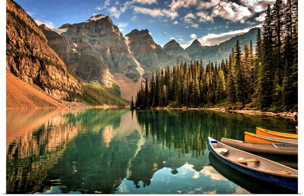 Photograph of a still lake with canoes in the Canadian Rockies, Banff National Park.