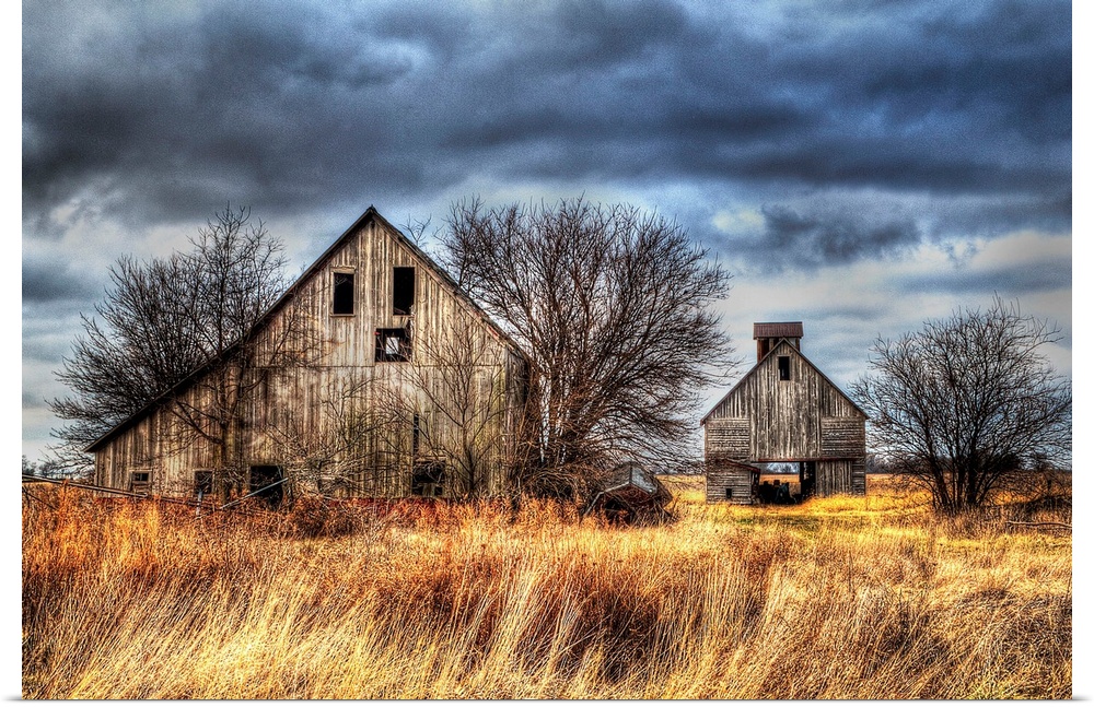 An image of two farm outbuildings under a dark and stormy sky.
