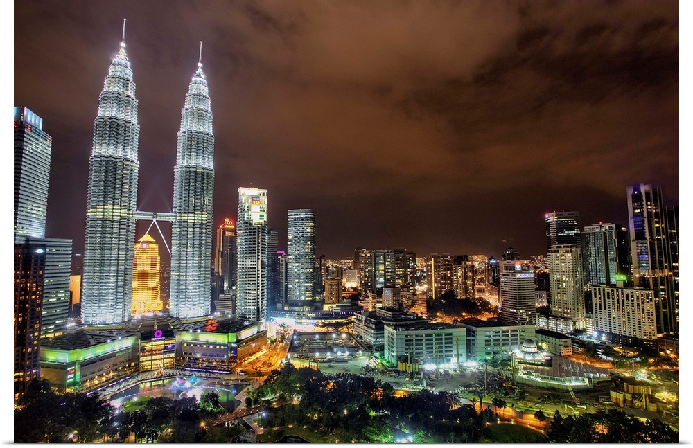 The Petronas Towers rising above the Kuala Lumpur city skyline at night, Malaysia.