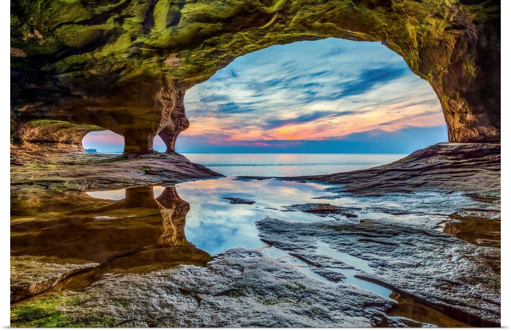 The sun sets on Lake Superior as photographed from a sea cave on a stretch of rocky coast in Michigan's Upper Peninsula.