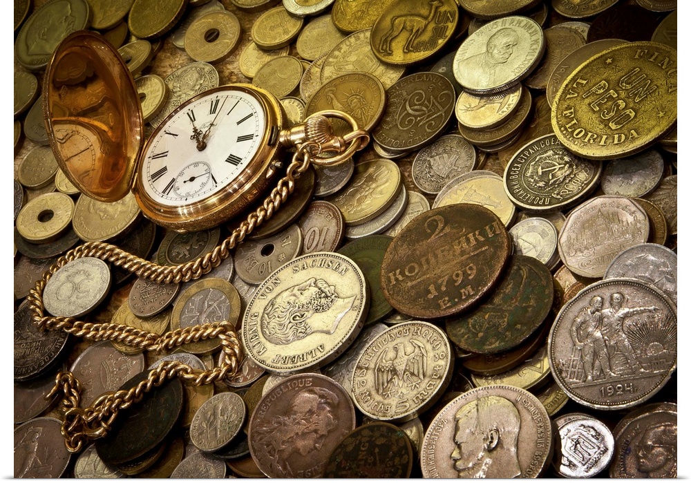 A collection of coins with a gold pocketwatch.