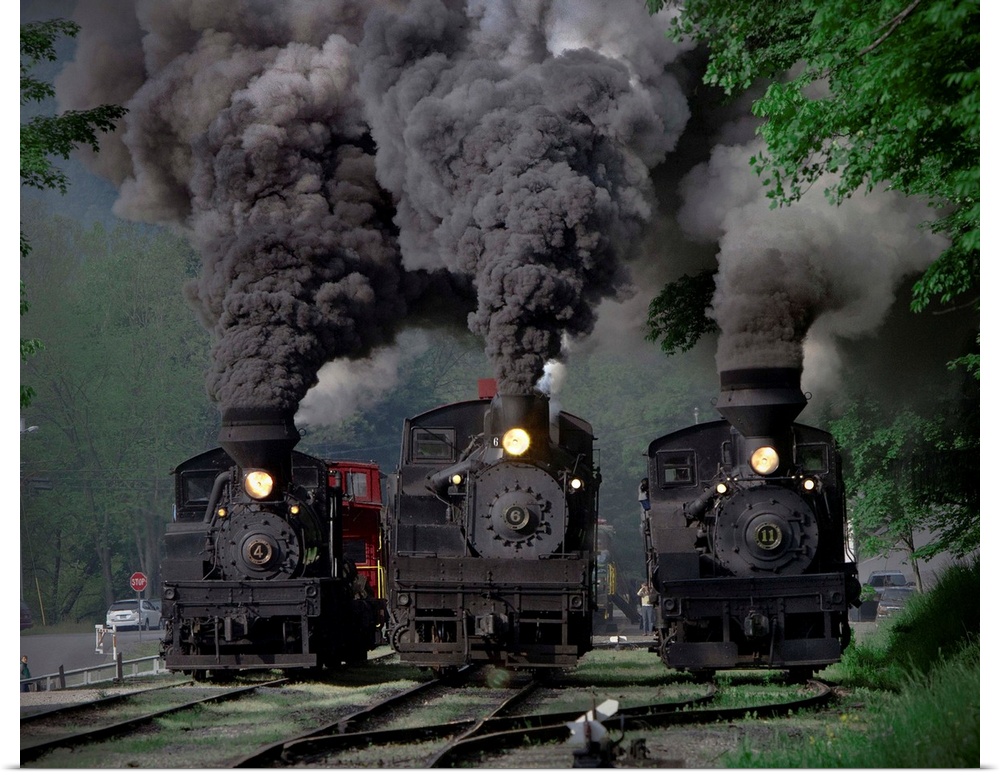Three locomotives powering down the tracks.