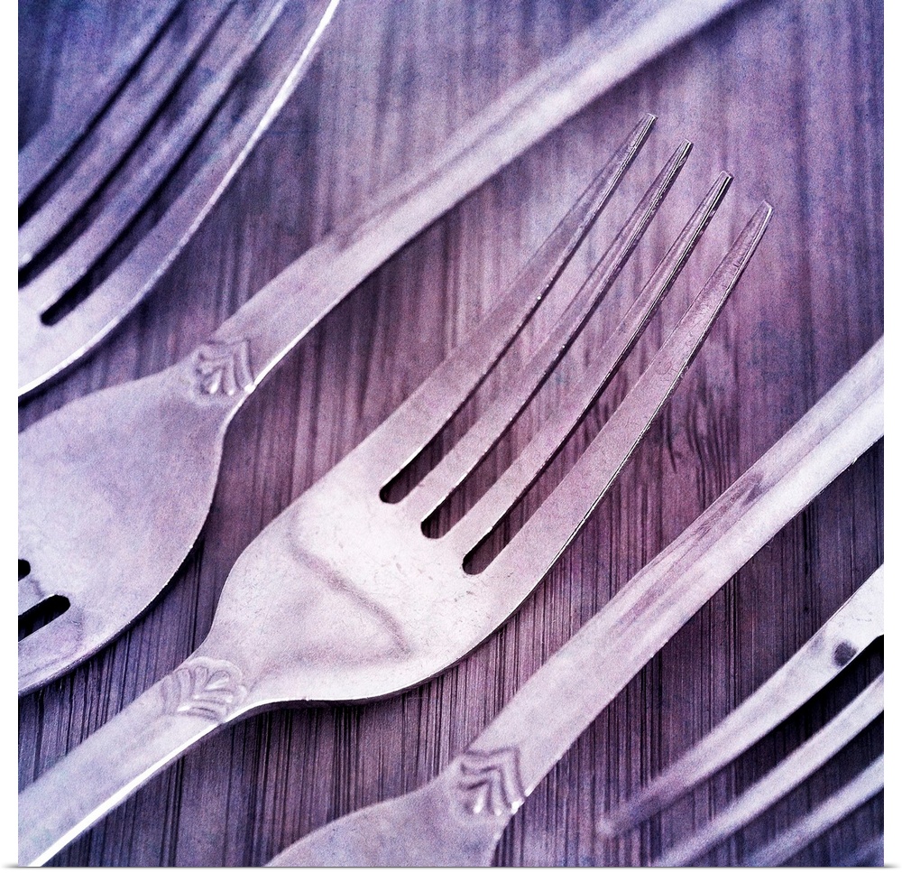 Forks, arranged on wood.