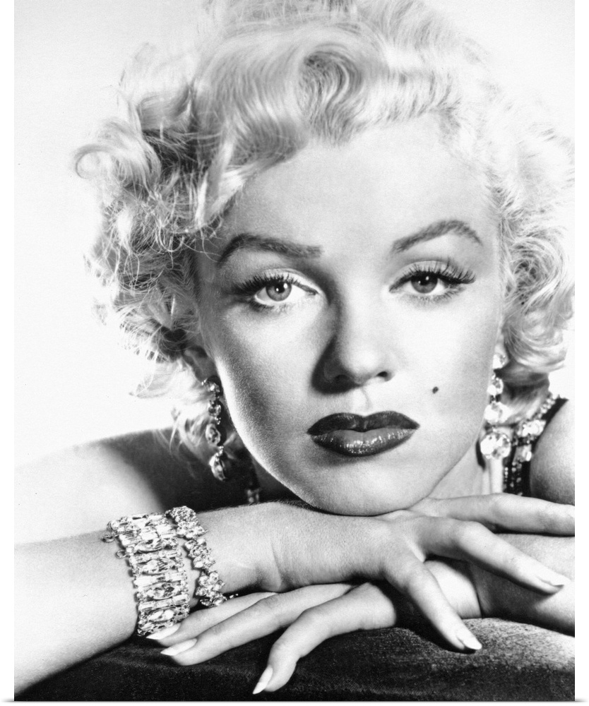 This is a monochromatic portrait photograph from the shoulders up of the Hollywood Icon wearing makeup and diamonds with h...
