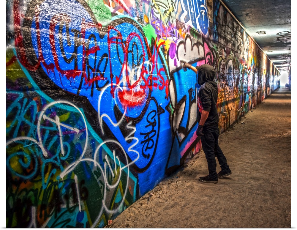 A graffiti artist adds to a mural in the Krog Street Tunnel, which connects Inman Park and Cabbagetown, downtown Atlanta, ...