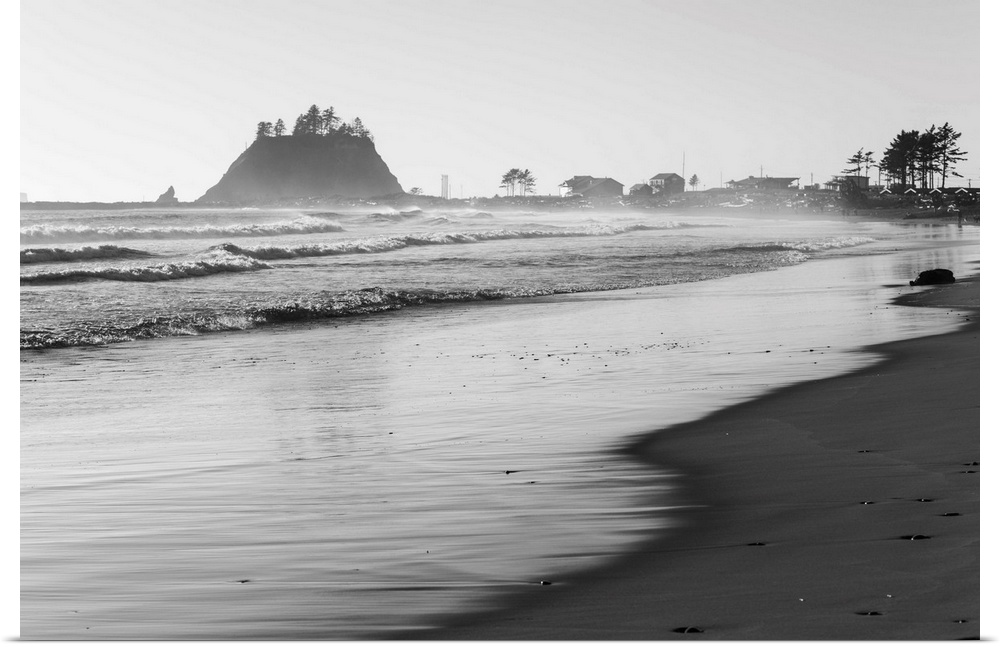 Black and white landscape photograph of the La Push Beach shore with misty rock cliffs in the background.