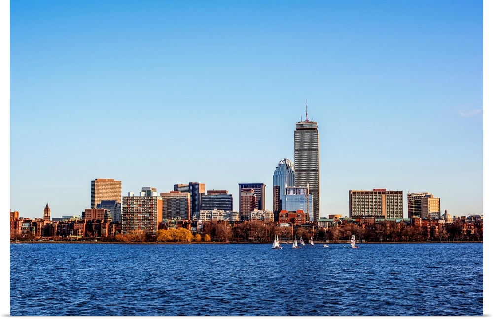 View of Boston city skyline and Prudential Tower with sailboats on the Charles River.