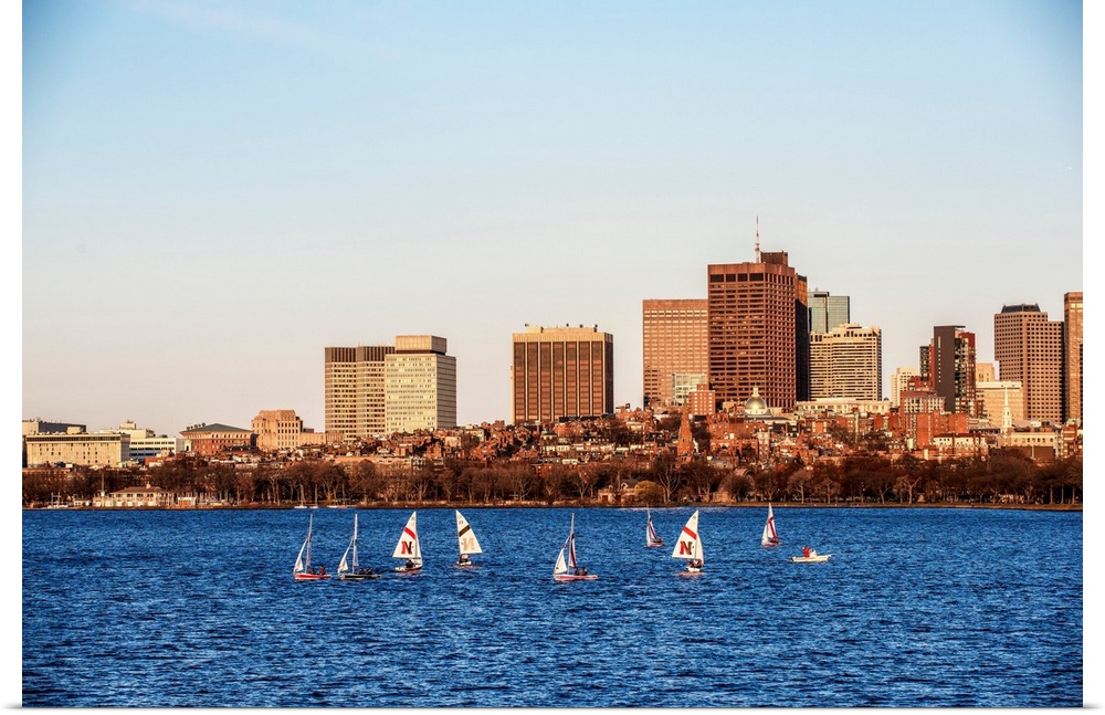 View of Boston city skyline with sailboats on the Charles River.