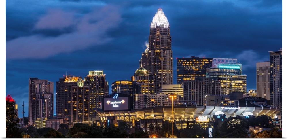 A horizontal image of the Charlotte, North Carolina city skyline at night.