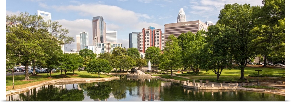 A water fountain in the foreground and Charlotte skyline in the background.