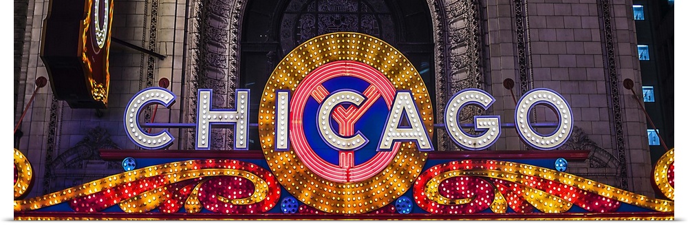 Panoramic image of the Chicago Theater Marquee with glowing lights in the evening.