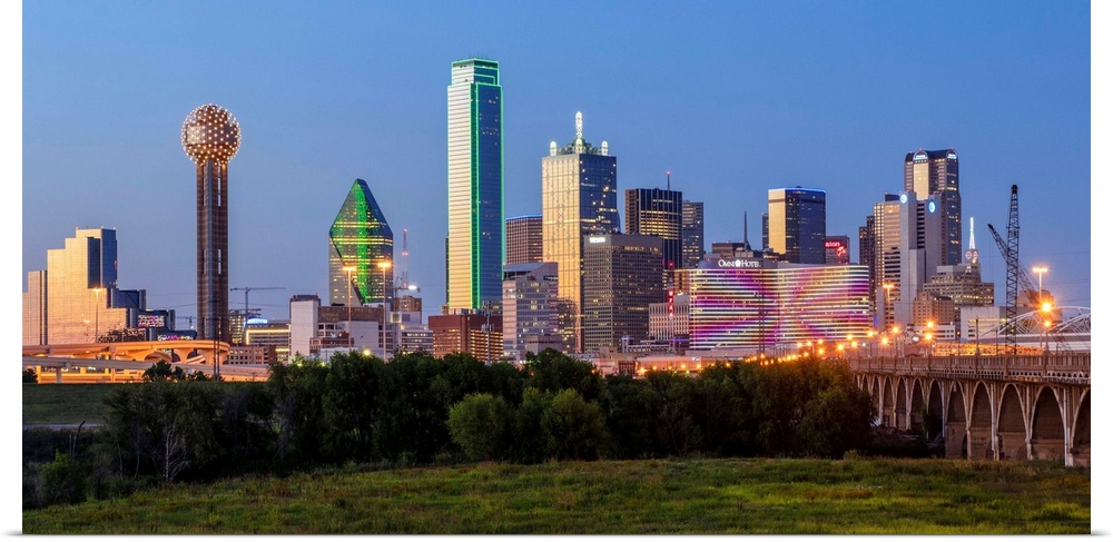 A horizontal image of  the Dallas, Texas city skyline at sunset.