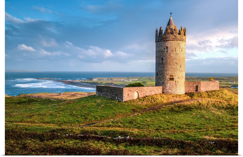 Photograph of Doonagore Castle in Doolin in County Clare, Ireland, with a beautiful sunset.