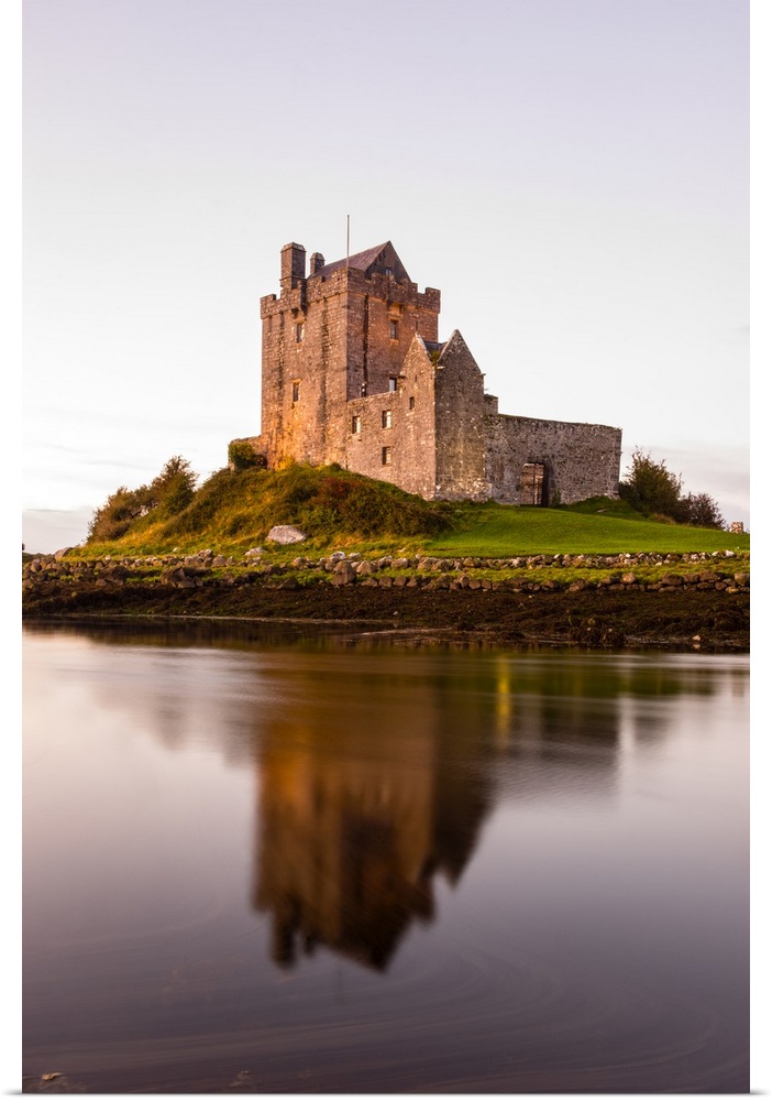 Vertical photograph of the Dunguaire Castle reflecting into the water on the southeastern shore of Galway Bay in County Ga...